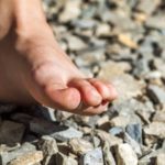 close up of bare foot walking on stones outdoors 2023 11 27 05 30 14 utc