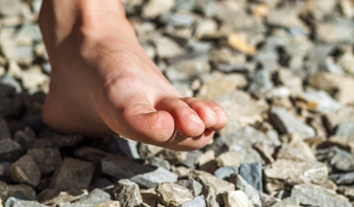 close up of bare foot walking on stones outdoors 2023 11 27 05 30 14 utc